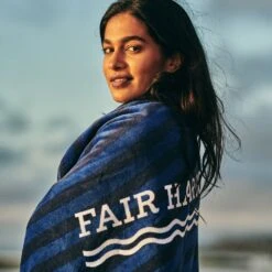 The FH Organic Beach Towel | Navy Waves -Fair Harbor Shop towel onmodel d88cfc96 8e65 4c40 b901 f5532bee0e97
